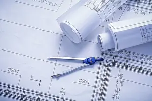 Construction Plan Blueprint Stampe: Vertical version compass and rolled blueprints close up