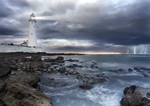 Towering Lighthouse Structure Stampe: A view of a lighthouse a storm
