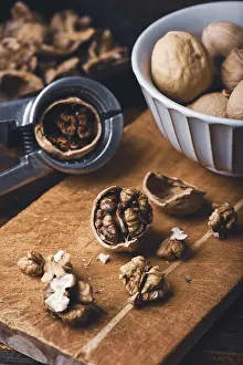 Vegan Meal Ideas Stampe: Walnuts and nutcracker on wooden surface