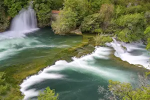 Eastern European Landscapes Stampe: A waterfall flows into a river