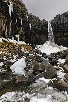 Waterfall In Winter Stampe: Waterfall, stream, basalt columns