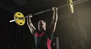 Weight Training Routine Stampe: Weightlifter does an exercise with a barbell