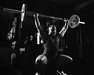 Young Weightlifter Stampe: Weightlifter does an exercise with a barbell