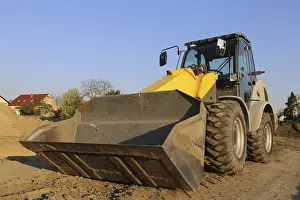 Construction Site Germany Stampe: Wheel loader at sunset, here in the RingstraBe development area (Mutterstadt)