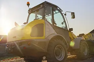 Construction Site Germany Stampe: Wheel loader at sunset, here in the RingstraBe development area (Mutterstadt)