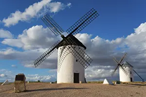 Castile La Mancha Landscapes Stampe: Windmill in a rural setting under a blue sky with dramatic clouds