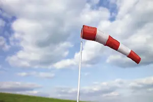 Cloudy Sky Stampe: Windsock in front of clouds in the sky