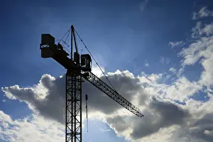 Deserted Construction Site Stampe: Working crane on cloudy sky