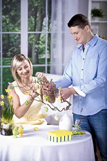 Holiday Home Decor Stampe: Young couple decorating for Easter