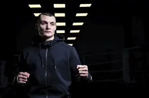 Martial Arts Concept Stampe: Young kickboxer posing in the studio