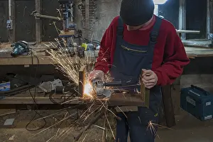 Young Man In Workshop Stampe: Young man at a Flex in his workshop