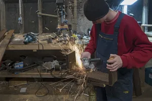 Northern German Youth Stampe: Young man at a Flex in his workshop